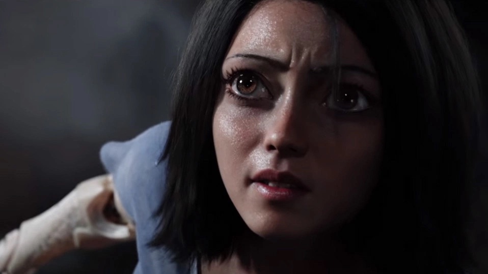 The live-action Alita, with giant eyes, looking up with concern and sweating