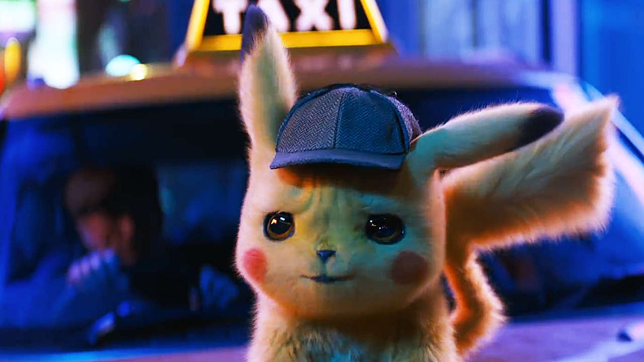 Detective Pikachu from the movie looking concerned while standing on top of a car hood.