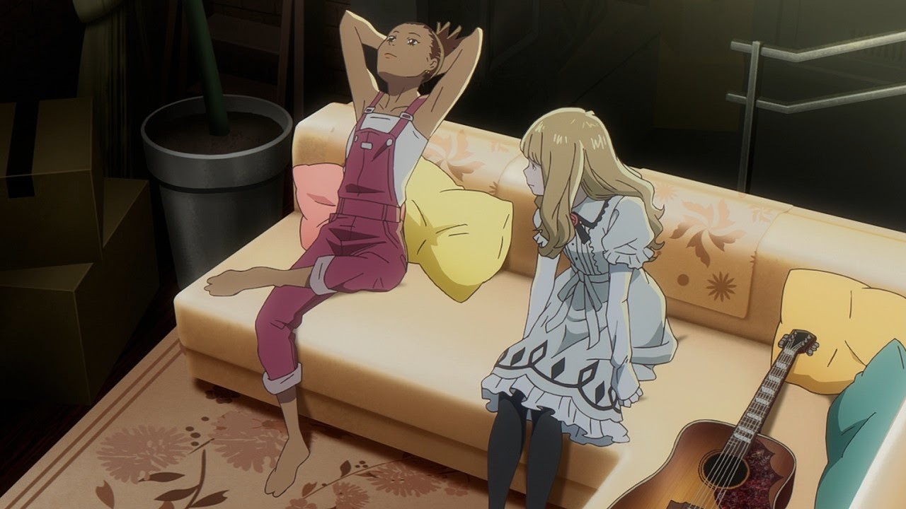 Shot from Carole & Tuesday. The two titular girls sitting on a couch with a guitar lying next to Tuesday.