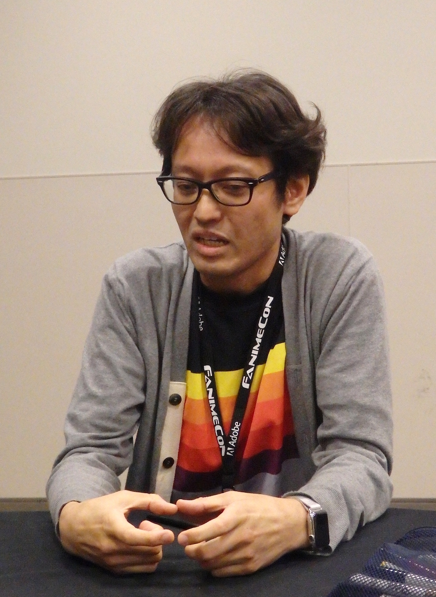 Kobayashi talking while gesturing with his hands