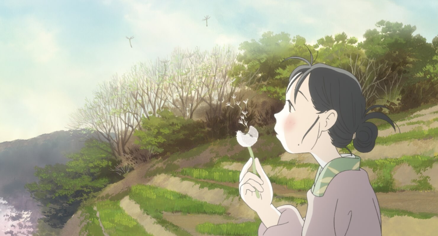 Suzu (the main character of the film) blowing dandelion seeds into the wind.