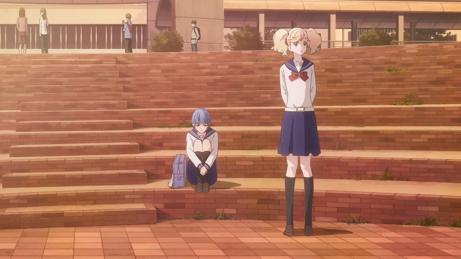 Ai sitting on stairs outside the school with her legs pulled up. Sarasa is standing out in front of her.