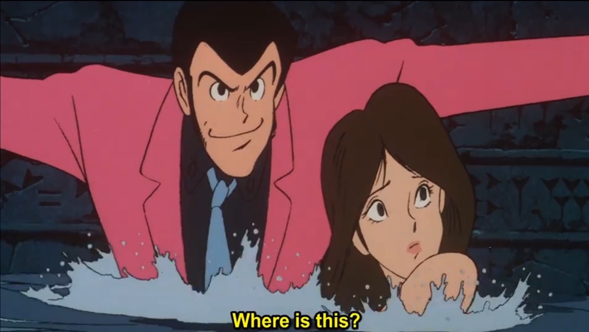 Lupin holding his arms out to stay afloat in rushing water, with Fujiko looking uncertain next to him. She asks “where is this?”