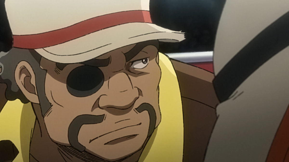 Nanbu frowning and looking to the side. He’s wearing a cap and an eyepatch.