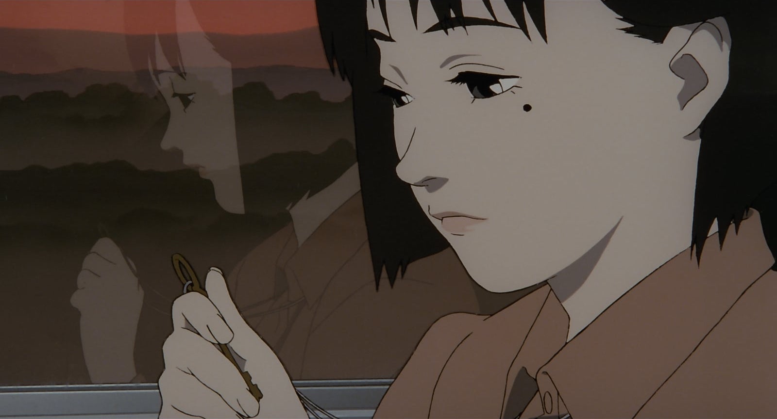 A young Chiyoko looking wistfully at a key in her hand.