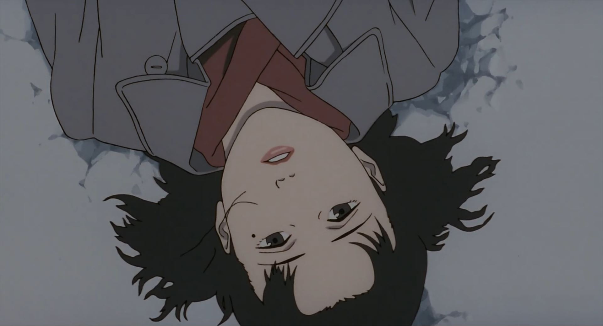 A middle-aged Chiyoko lying down face-up in the snow.