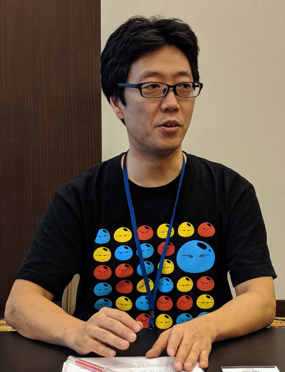 Atsushi Nakayama speaking at a table.