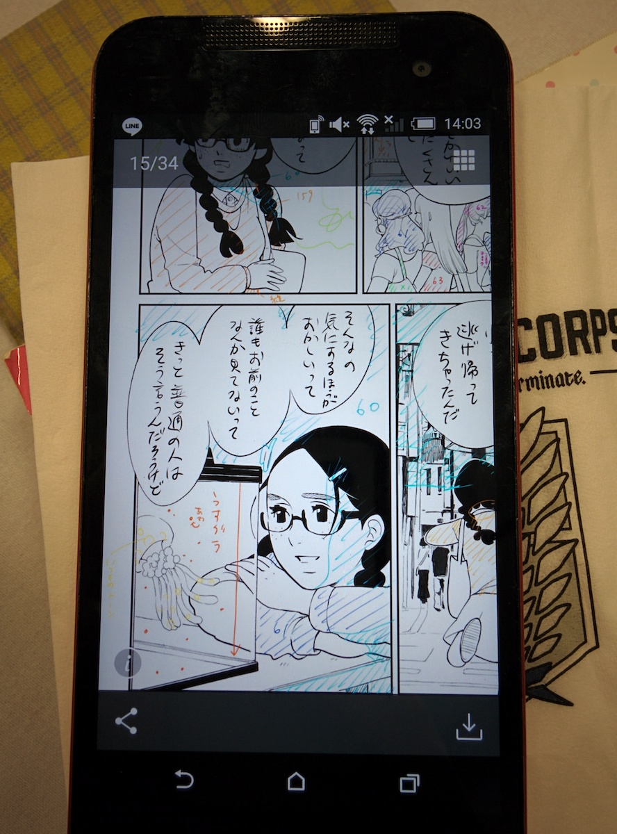 A cell phone with rough manga drawings. There are lots of colored lines
