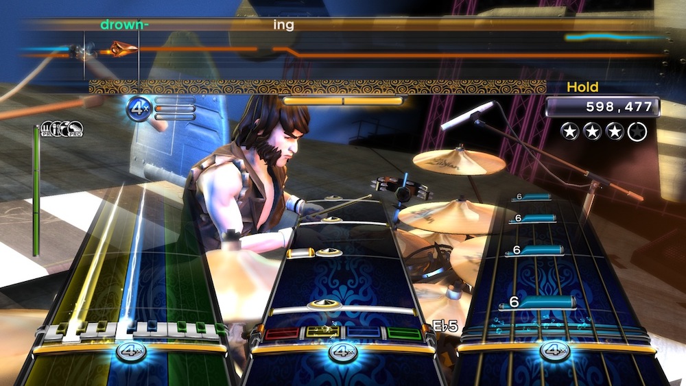 A song being played in Rock Band 3 with all four instruments: bass, drums, guitar, and vocals.