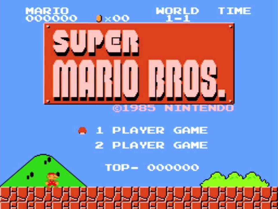 Title screen of Super Mario Bros. Mario is standing on the ground with mountains behind him.