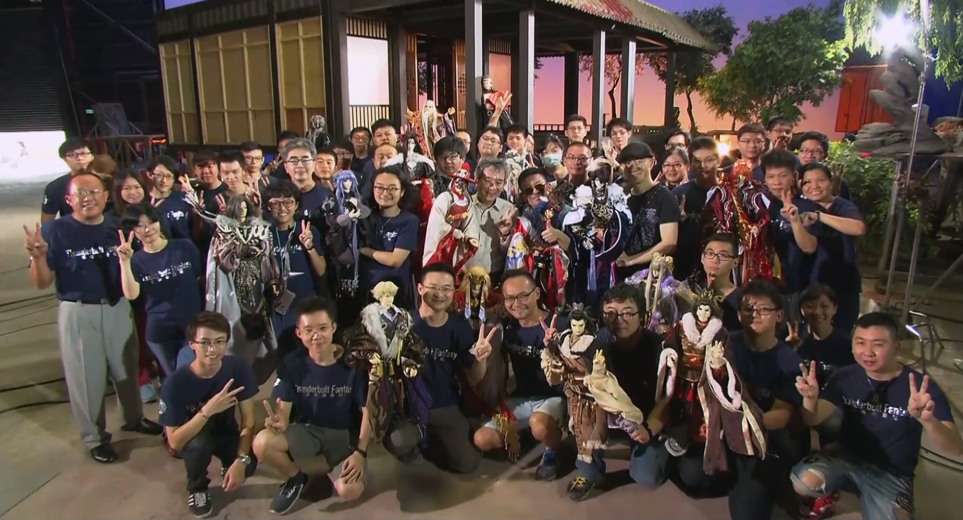The cast and puppets of Thunderbolt Fantasy arranged bleacher style in a group photo at the wrap of show.
